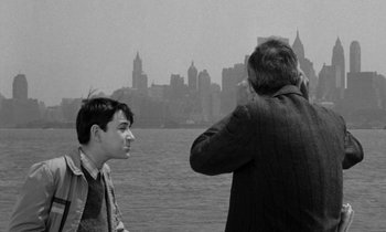 Movie still from “A Thousand Clowns” (1965), directed by Fred Coe – A man taking a picture of another man on a boat; Medium shot, Over the shoulder angle