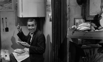 Movie still from “A Thousand Clowns” (1965), directed by Fred Coe – A black and white photo of a man in a suit; Medium shot, High angle