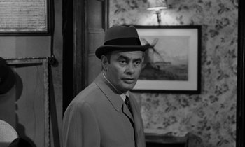 Movie still from “A Thousand Clowns” (1965), directed by Fred Coe – A black and white photo of a man wearing a hat; Medium shot, Over the shoulder angle