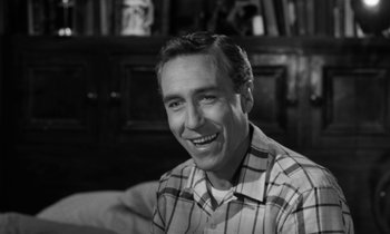 Movie still from “A Thousand Clowns” (1965), directed by Fred Coe – Black and white photograph of a man smiling for the camera; Close Up shot, High angle