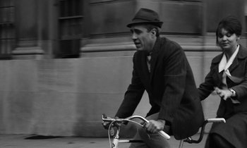 Movie still from “A Thousand Clowns” (1965), directed by Fred Coe – A black and white photo of a man riding a bike; Medium shot, High angle