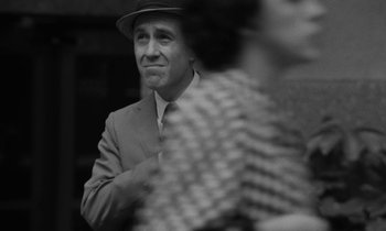 Movie still from “A Thousand Clowns” (1965), directed by Fred Coe – A black and white photo of a man wearing a hat; Close Up shot, Over the shoulder angle