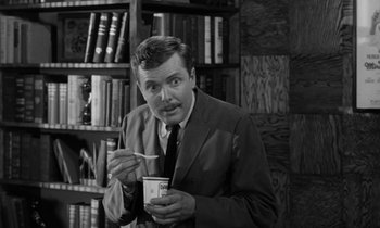 Movie still from “A Thousand Clowns” (1965), directed by Fred Coe – A black and white photo of a man eating ice cream; Close Up shot, Over the shoulder angle