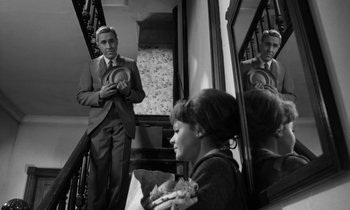 Movie still from “A Thousand Clowns” (1965), directed by Fred Coe – A man and a woman in front of a mirror in a room; Medium shot, Over the shoulder angle