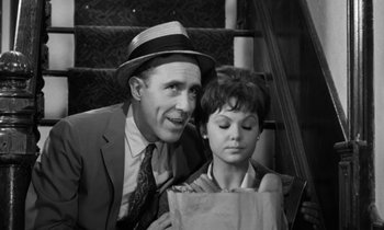 Movie still from “A Thousand Clowns” (1965), directed by Fred Coe – An old photo of a man and a young girl; Medium shot, High angle