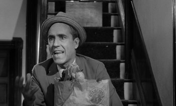 Movie still from “A Thousand Clowns” (1965), directed by Fred Coe – A black and white photo of a man holding a paper bag; Close Up shot, High angle