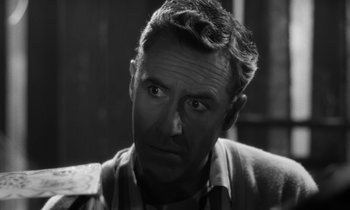 Movie still from “A Thousand Clowns” (1965), directed by Fred Coe – An old photo of an older man looking at the camera; Close Up shot, Over the shoulder angle