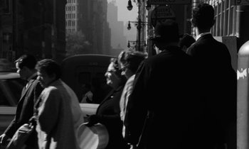 Movie still from “A Thousand Clowns” (1965), directed by Fred Coe – A black and white photo of people walking on a street; Wide shot, High angle