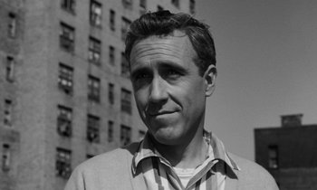 Movie still from “A Thousand Clowns” (1965), directed by Fred Coe – Black and white photograph of a man in front of a building; Close Up shot, Low angle
