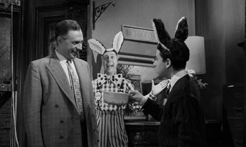 Movie still from “A Thousand Clowns” (1965), directed by Fred Coe – Two men and a woman wearing bunny ears; Medium shot, Over the shoulder angle