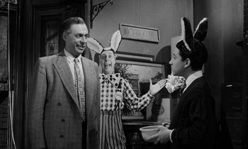 Movie still from “A Thousand Clowns” (1965), directed by Fred Coe – A man and two women wearing bunny ears; Medium shot, Over the shoulder angle