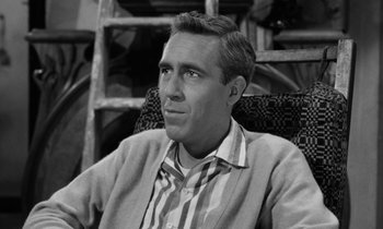 Movie still from “A Thousand Clowns” (1965), directed by Fred Coe – Black and white photograph of a man sitting in a chair; Close Up shot, High angle