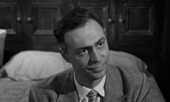 Movie still from “A Thousand Clowns” (1965), directed by Fred Coe – Black and white photograph of a man wearing a suit and tie; Close Up shot, High angle