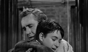 Movie still from “A Thousand Clowns” (1965), directed by Fred Coe – An older man and a young boy hugging each other; Medium shot, High angle
