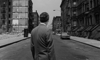 Movie still from “A Thousand Clowns” (1965), directed by Fred Coe – A black and white photo of a man walking down a city street; Wide shot, High angle