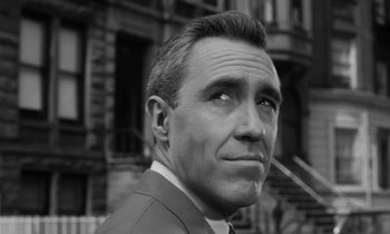 Movie still from “A Thousand Clowns” (1965), directed by Fred Coe – Black and white photograph of a man in front of a building; Close Up shot, Low angle