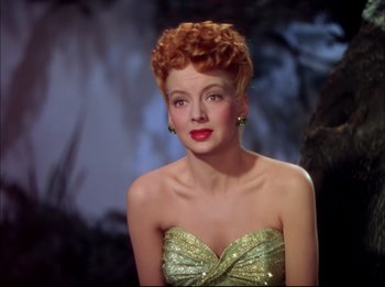 A woman with red hair and a green dress