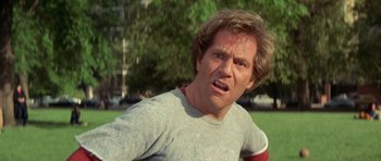 Movie still from “A Touch of Class” (1973), directed by Melvin Frank – A person wearing a t - shirt with trees in the background; Close Up shot, Low angle