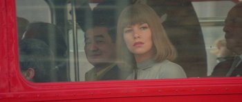 A man and a woman sitting in a bus