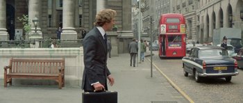 Movie still from “A Touch of Class” (1973), directed by Melvin Frank – A man walking down a street holding a briefcase; Wide shot, Over the shoulder angle