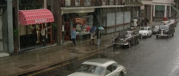 Movie still from “A Touch of Class” (1973), directed by Melvin Frank – People walking in the rain on the sidewalk; Extreme Wide shot, High angle