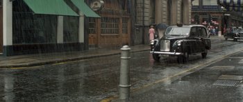Movie still from “A Touch of Class” (1973), directed by Melvin Frank – A car driving down the street in the pouring rain; Wide shot, High angle