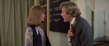 Movie still from “A Touch of Class” (1973), directed by Melvin Frank – A man and a woman talking to each other; Medium shot, Over the shoulder angle