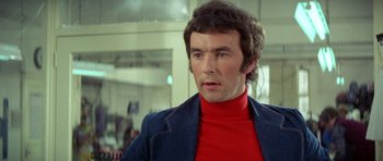 Movie still from “A Touch of Class” (1973), directed by Melvin Frank – A person wearing a red shirt; Close Up shot, Low angle