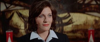 Movie still from “A Touch of Class” (1973), directed by Melvin Frank – A person wearing a suit and tie; Close Up shot, Low angle