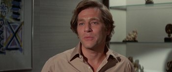 Movie still from “A Touch of Class” (1973), directed by Melvin Frank – A person wearing a shirt; Close Up shot, Low angle