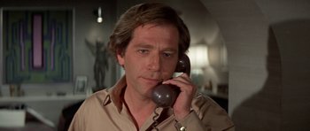 Movie still from “A Touch of Class” (1973), directed by Melvin Frank – A person talking on a phone; Close Up shot, Low angle
