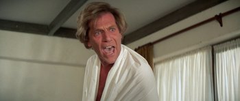 Movie still from “A Touch of Class” (1973), directed by Melvin Frank – A person wearing a white shirt; Close Up shot, Low angle