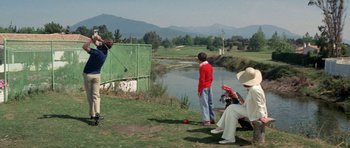 Movie still from “A Touch of Class” (1973), directed by Melvin Frank – A group of people on a field playing golf; Wide shot, Low angle