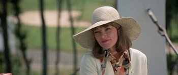 Movie still from “A Touch of Class” (1973), directed by Melvin Frank – A woman wearing a straw hat and a white shirt; Close Up shot, Low angle