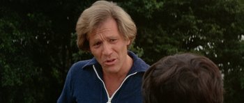 Movie still from “A Touch of Class” (1973), directed by Melvin Frank – An older man with long blonde hair talking to a younger man; Close Up shot, Over the shoulder angle
