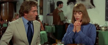 Movie still from “A Touch of Class” (1973), directed by Melvin Frank – A man and a woman sitting at a table in a restaurant; Medium shot, Over the shoulder angle