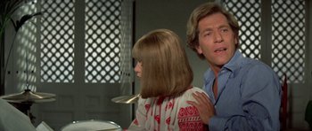 Movie still from “A Touch of Class” (1973), directed by Melvin Frank – A man and a woman are sitting in front of each other; Close Up shot, Over the shoulder angle