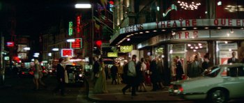 Movie still from “A Touch of Class” (1973), directed by Melvin Frank – A group of people walking down a street at night; Extreme Wide shot, High angle