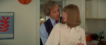 Movie still from “A Touch of Class” (1973), directed by Melvin Frank – A man and a woman standing next to each other in front of a mirror; Close Up shot, Low angle