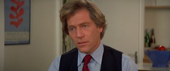 Movie still from “A Touch of Class” (1973), directed by Melvin Frank – A person wearing a suit and tie; Close Up shot, Low angle