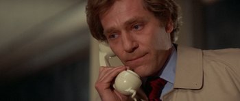Movie still from “A Touch of Class” (1973), directed by Melvin Frank – A person talking on a phone; Close Up shot, Low angle