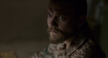 Movie still from “A War” (2015), directed by Tobias Lindholm – A person with a beard; Close Up shot, High angle