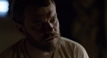 Movie still from “A War” (2015), directed by Tobias Lindholm – A person with a beard looking at the camera; Close Up shot, Over the shoulder angle