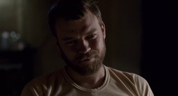 Movie still from “A War” (2015), directed by Tobias Lindholm – A person with a beard looking at the camera; Close Up shot, Over the shoulder angle