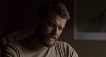 Movie still from “A War” (2015), directed by Tobias Lindholm – A person with a beard; Close Up shot, Over the shoulder angle