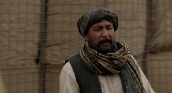 Movie still from “A War” (2015), directed by Tobias Lindholm – A man with a beard wearing a scarf and a turban; Close Up shot, Low angle
