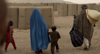 Movie still from “A War” (2015), directed by Tobias Lindholm – An afghan woman and a child walking in the desert; Wide shot, Over the shoulder angle