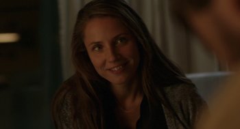 Movie still from “A War” (2015), directed by Tobias Lindholm – A woman smiling for the camera with long hair; Close Up shot, Over the shoulder angle