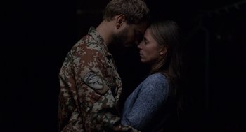 Movie still from “A War” (2015), directed by Tobias Lindholm – A man and a woman are standing next to each other; Medium shot, Over the shoulder angle