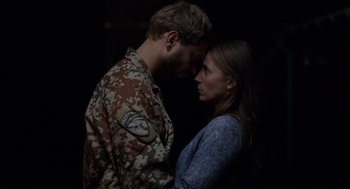 Movie still from “A War” (2015), directed by Tobias Lindholm – A man and a woman standing next to each other; Close Up shot, Over the shoulder angle